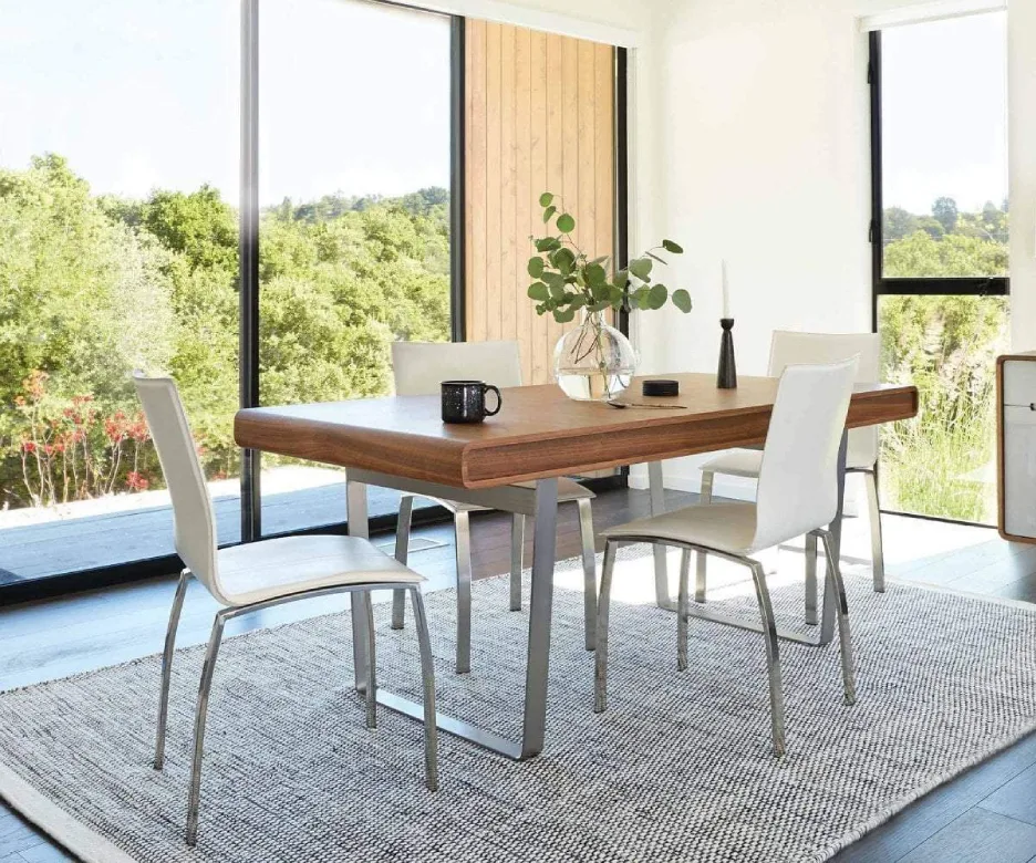 Minimalist Scandi-chic dining room with light oak furniture and an airy white aesthetic—modern NRI vacation home in Narasimukku.